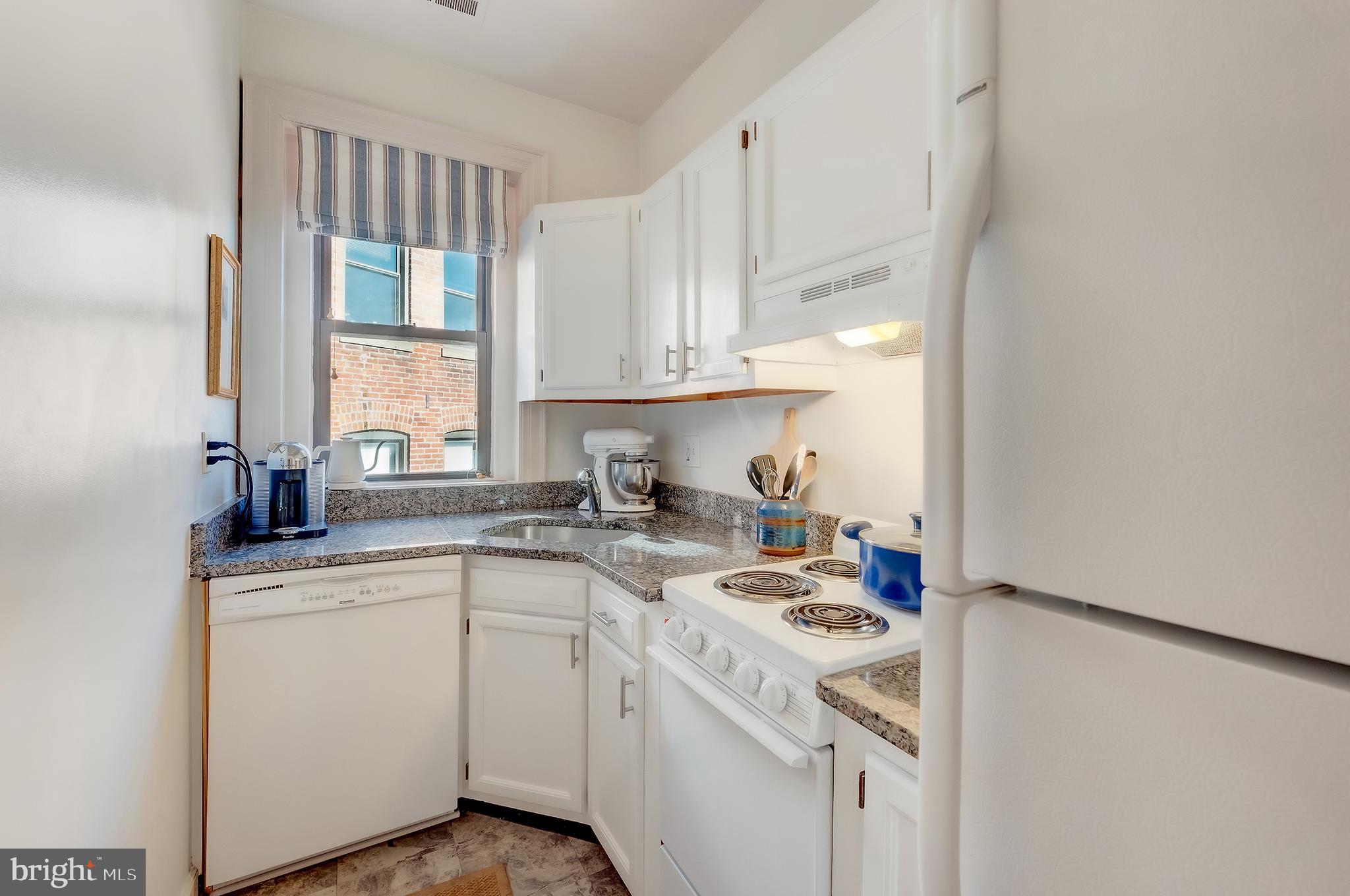 1918 18th Street Northwest, Unit 42 Washington, DC 20009 - Photo 9 of 22 a kitchen with a sink stove and cabinets