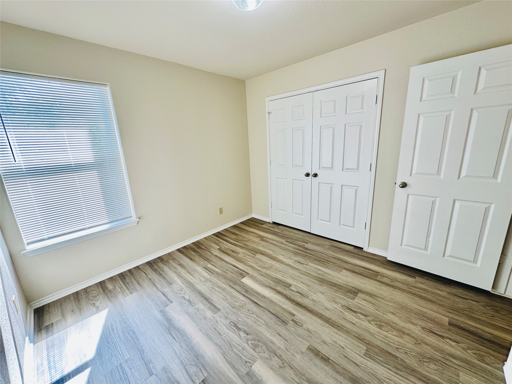8814 Schick Road, Unit C Austin, TX 78729 - Photo 27 of 35 A well-lit room showcases new wood-look flooring and ample closet space.