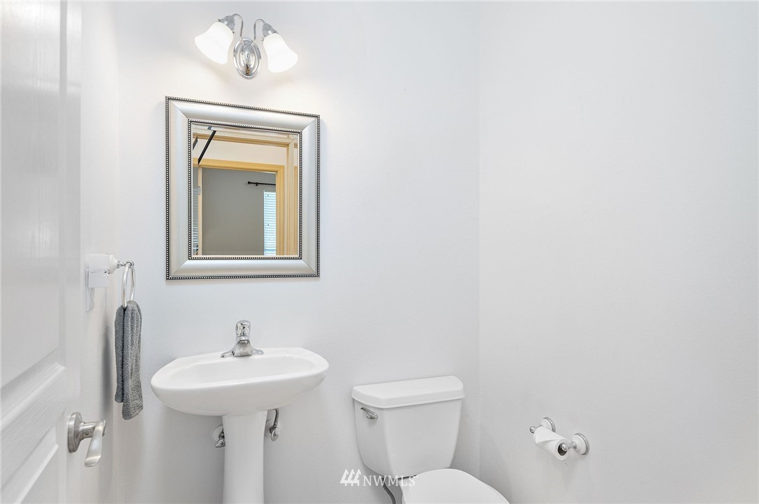 2988 Rickey Road Bremerton, WA 98310 - Photo 13 of 34 a bathroom with a toilet sink and mirror