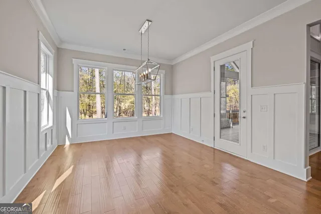 a view of an empty room with glass door and windows