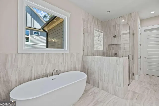 a bathroom with a bathtub and shower