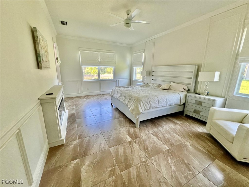 7121 Hatpin Loop Wesley Chapel, FL 33545 - Photo 13 of 24 a spacious bedroom with a bed and a couch