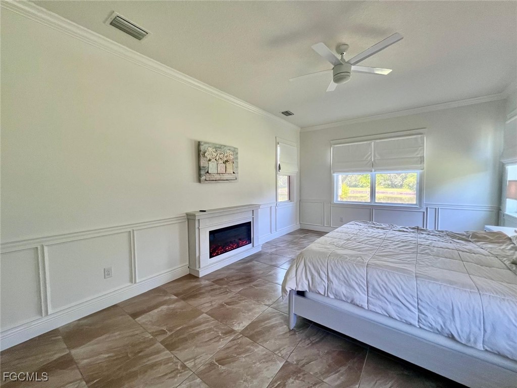 7121 Hatpin Loop Wesley Chapel, FL 33545 - Photo 14 of 24 a spacious bedroom with a bed and a window