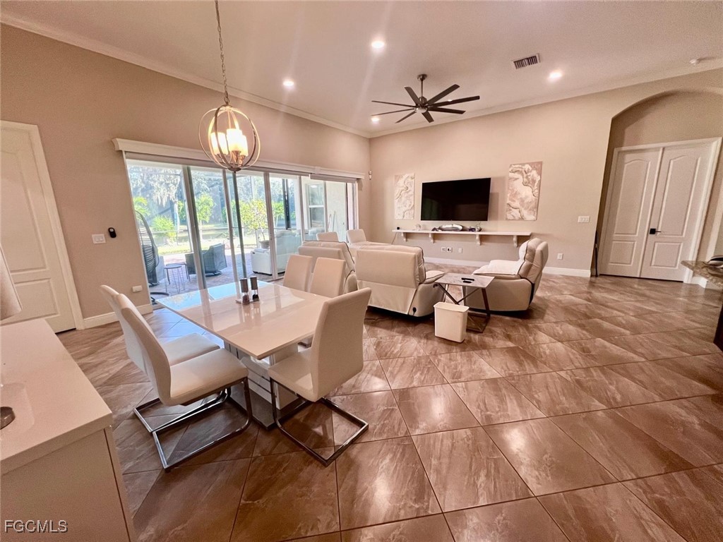 7121 Hatpin Loop Wesley Chapel, FL 33545 - Photo 3 of 24 a living room with couches a flat screen tv and kitchen view