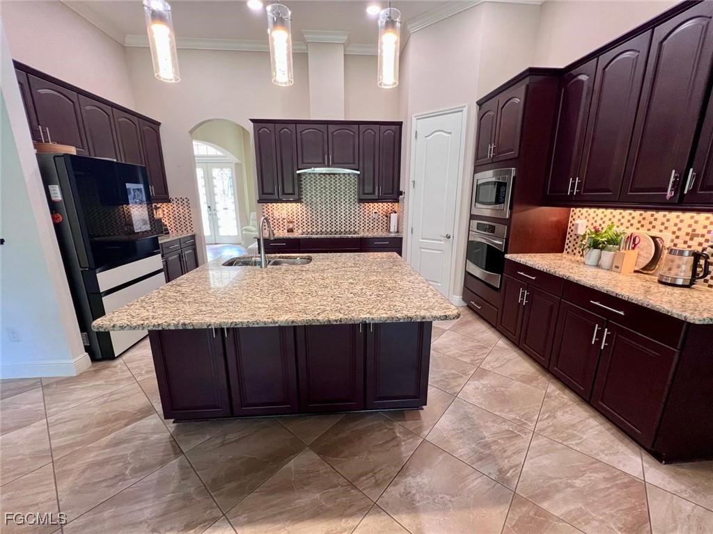 7121 Hatpin Loop Wesley Chapel, FL 33545 - Photo 5 of 24 a kitchen with stainless steel appliances granite countertop wooden cabinets a sink and dishwasher