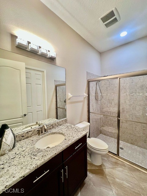 7121 Hatpin Loop Wesley Chapel, FL 33545 - Photo 9 of 24 a bathroom with a granite countertop sink a toilet and shower