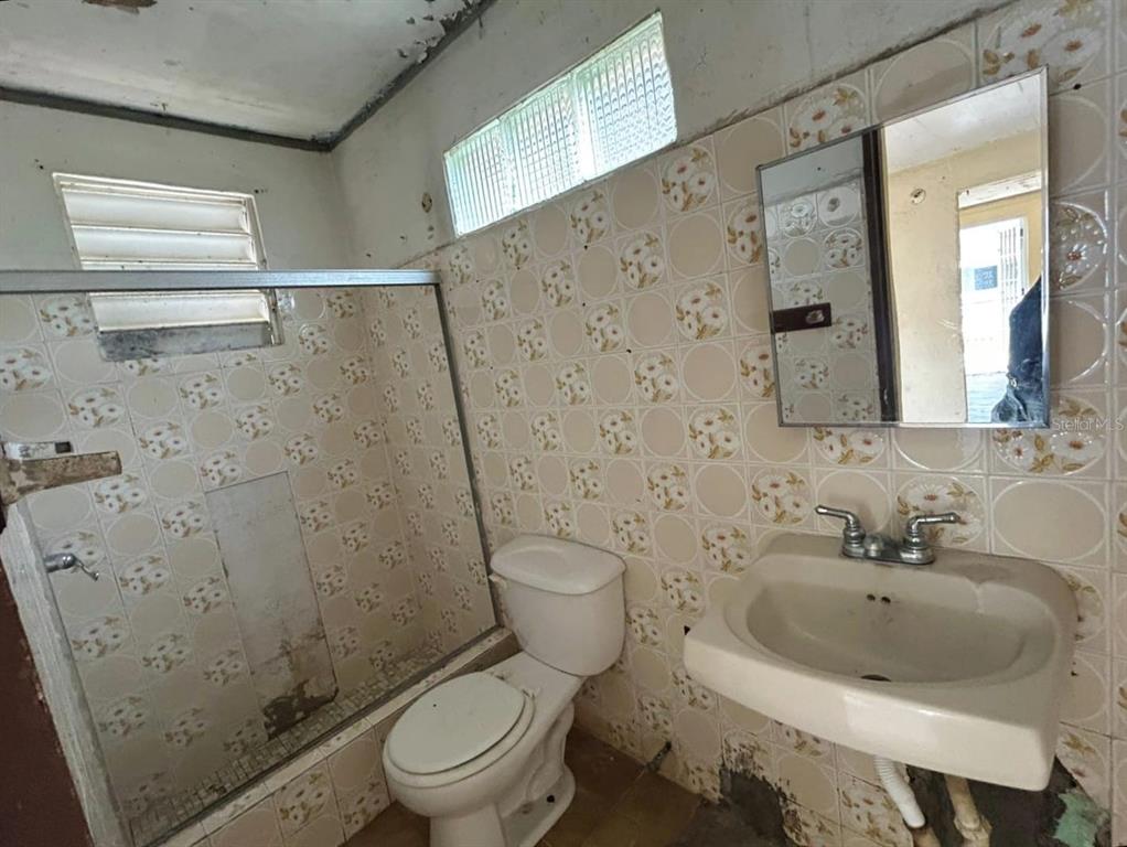 5 Calle Barceloneta, PR 00617 - Photo 23 of 40 a bathroom with a sink and toilet