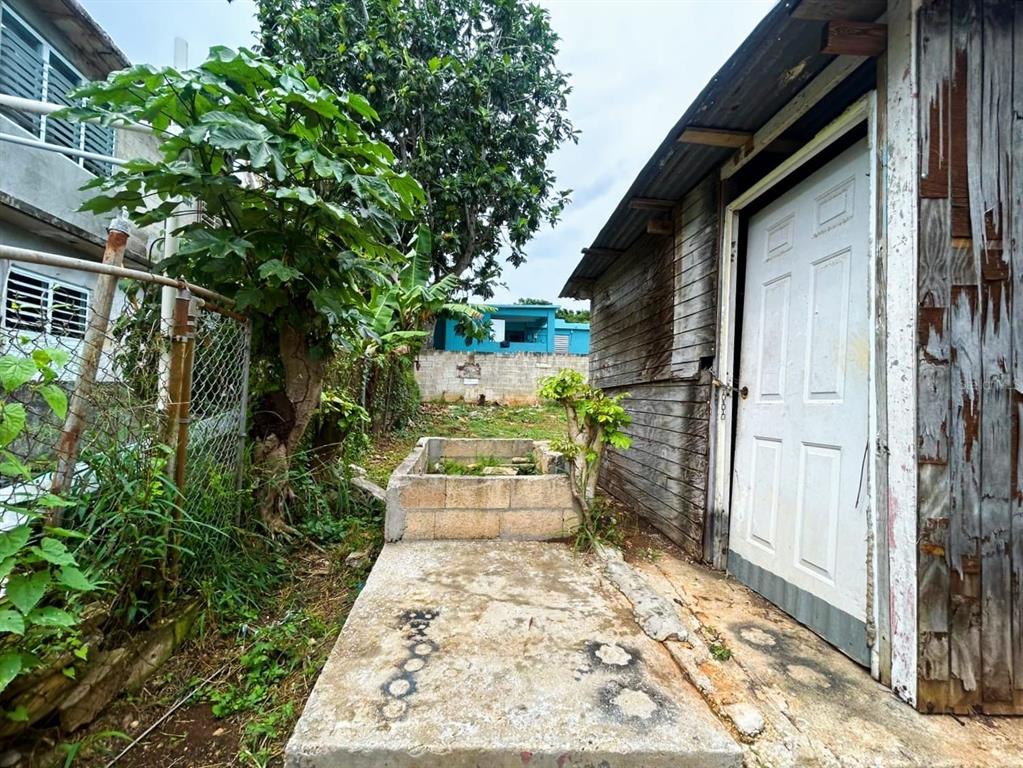 5 Calle Barceloneta, PR 00617 - Photo 39 of 40 a backyard of a house with yard and outdoor seating