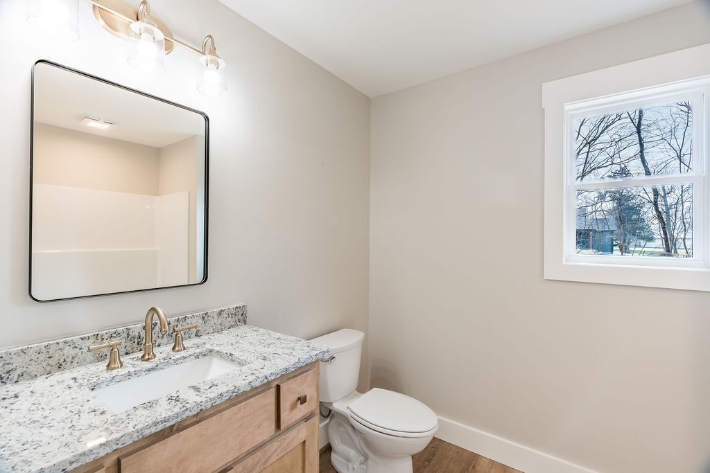 351 Chesnut Road Guthrie, KY 42234 - Photo 20 of 30 a bathroom with a granite countertop toilet a sink and mirror