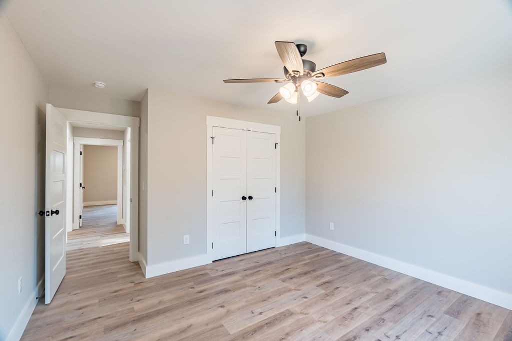351 Chesnut Road Guthrie, KY 42234 - Photo 24 of 30 an empty room with wooden floor fan and windows