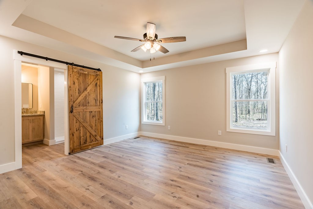 351 Chesnut Road Guthrie, KY 42234 - Photo 10 of 30 an empty room with wooden floor fan and windows