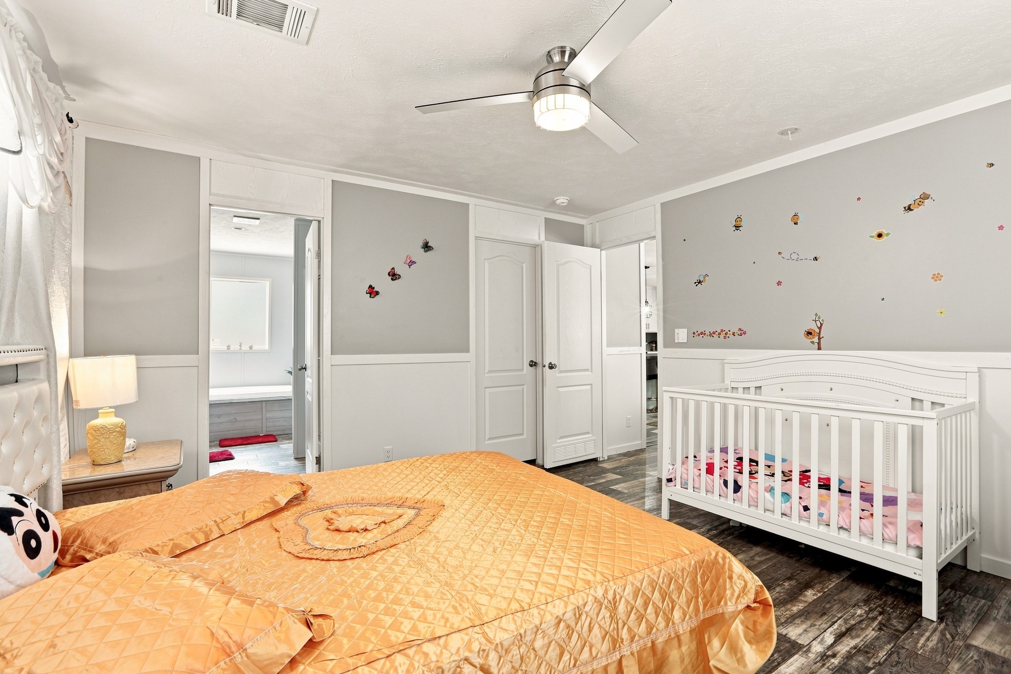 1039 Trailside Elgin, TX 78621 - Photo 12 of 24 Smooth wood-look flooring and custom wall paneling create a cohesive feel in this comfortable bedroom.