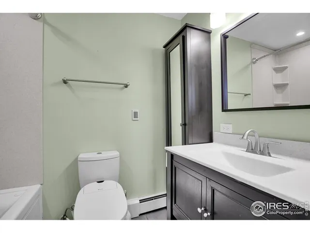 a bathroom with a sink toilet and mirror