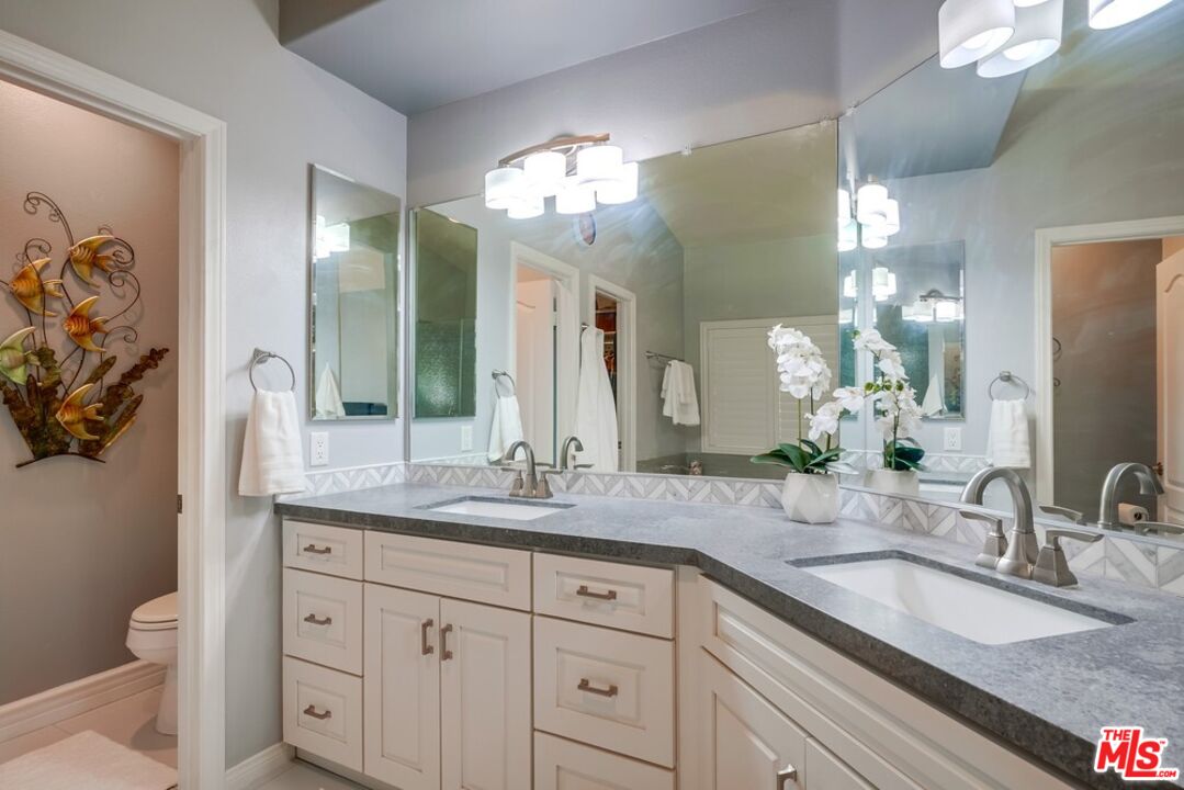 32377 Corte Santa Catalina Temecula, CA 92592 - Photo 14 of 27 a bathroom with a granite countertop double vanity sink and a mirror