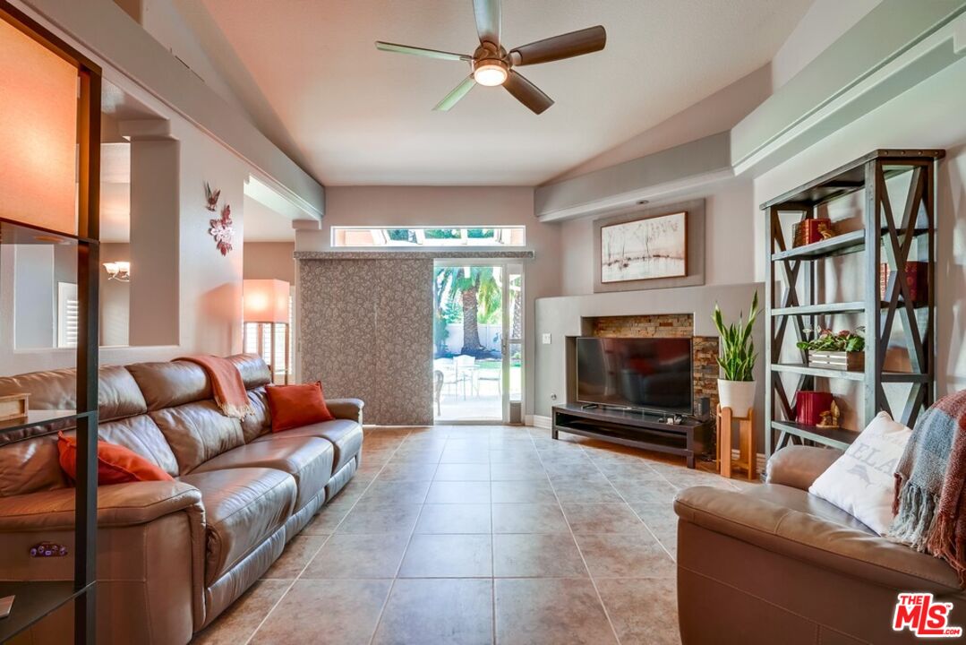 32377 Corte Santa Catalina Temecula, CA 92592 - Photo 4 of 27 a living room with furniture a flat screen tv and a fireplace