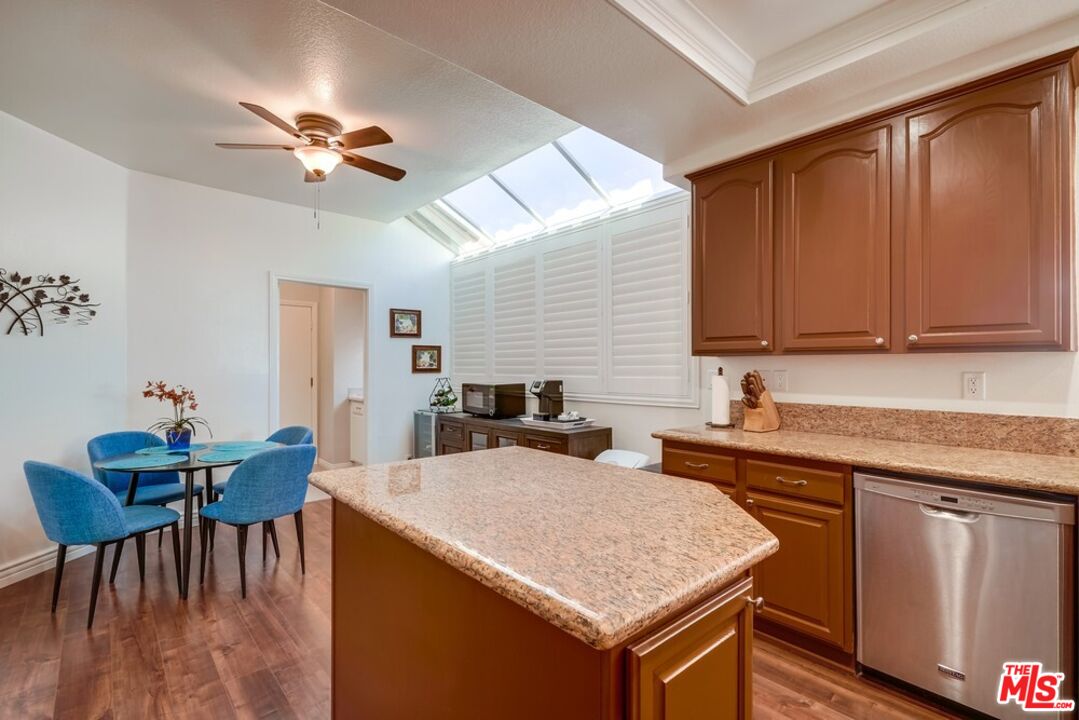 32377 Corte Santa Catalina Temecula, CA 92592 - Photo 8 of 27 a kitchen with a stove a sink a refrigerator dining table and chairs