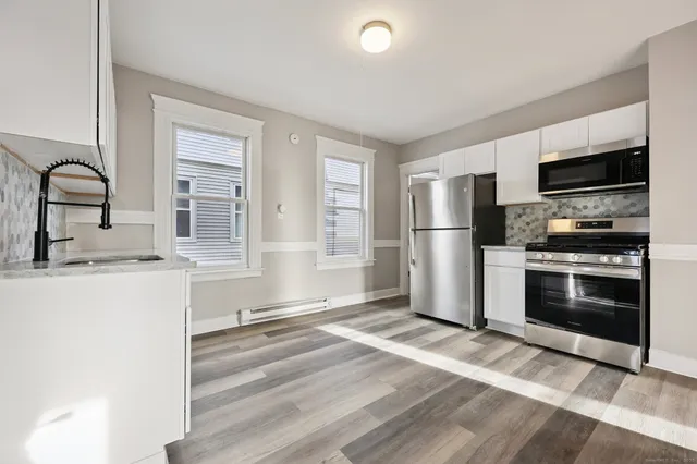 a view of a kitchen with a sink cabinets and a window