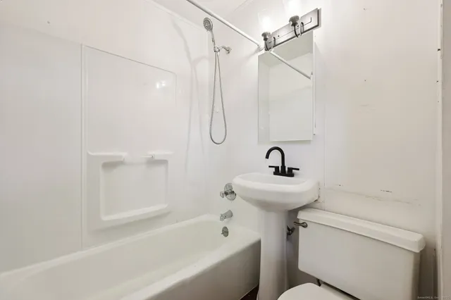 a picture of a bathroom with a shower