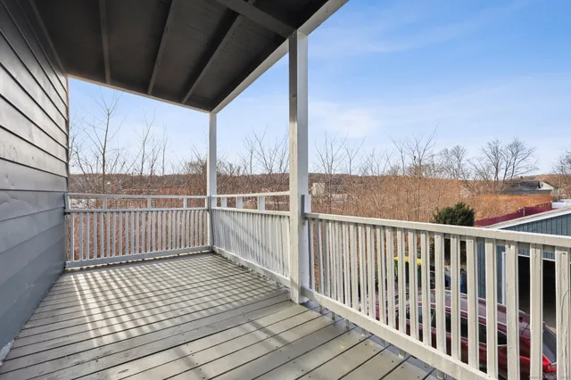 a view of a balcony with wooden floor