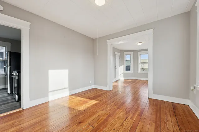wooden floor in an empty room with a window