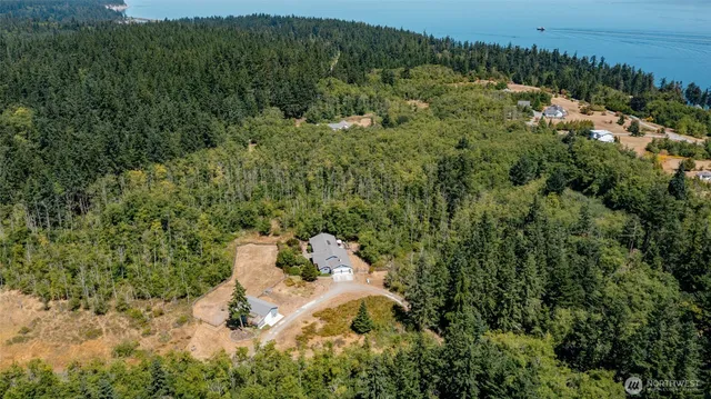 an aerial view of a house with a yard