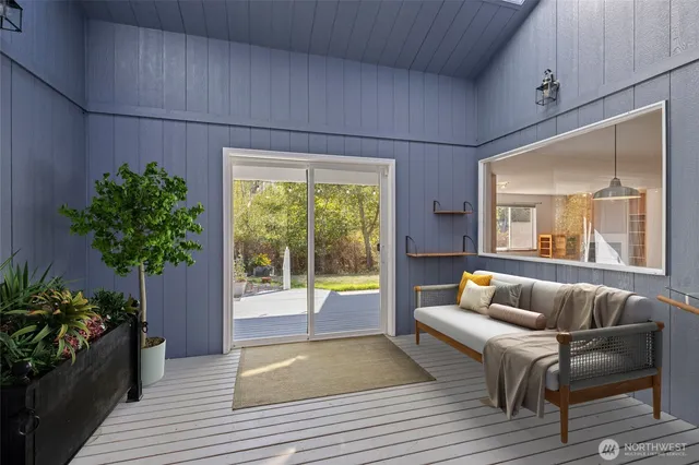 a large white bed in a room next to a window