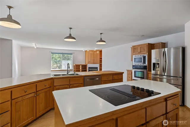a kitchen with stainless steel appliances granite countertop a sink stove and cabinets