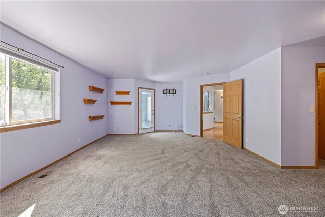 a spacious bathroom with double vanity and a large mirror