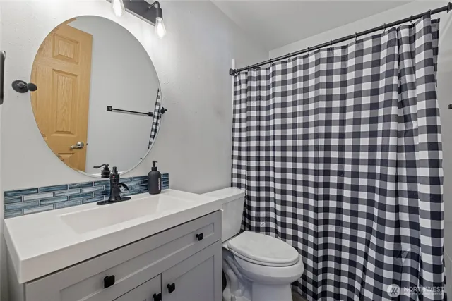 an empty room with a window and ceiling fan