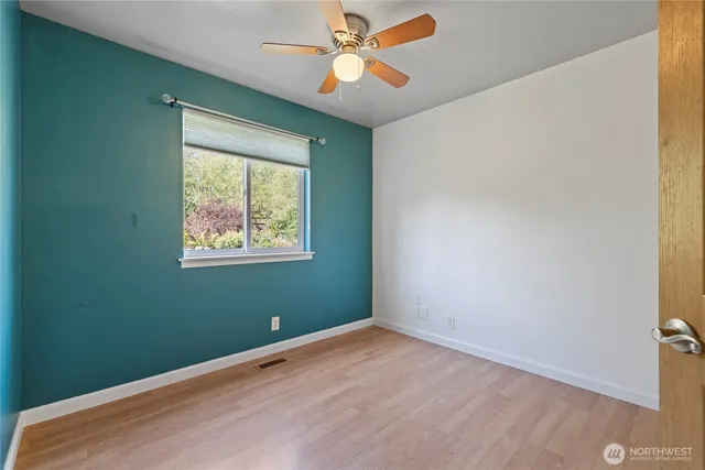 a bathroom with a granite countertop sink a toilet and a mirror