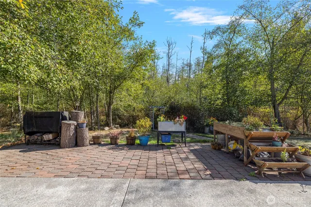 a view of a house with backyard porch and sitting area