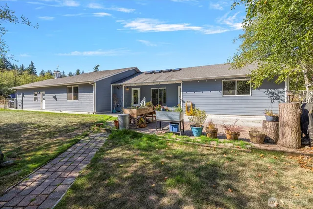 a backyard of a house with table and chairs