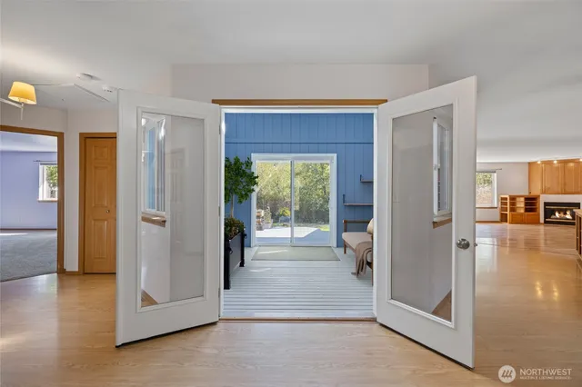 a living room with furniture and a large window with wooden floor