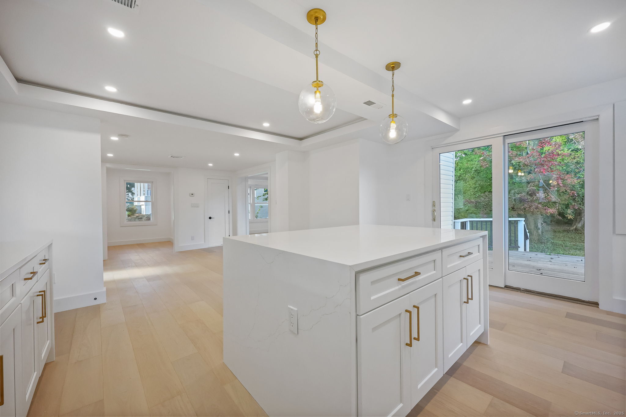 294 Thimble Island Road Branford, CT 06405 - Photo 11 of 39 a view of a kitchen center island with stainless steel appliances granite countertop furniture and a chandelier