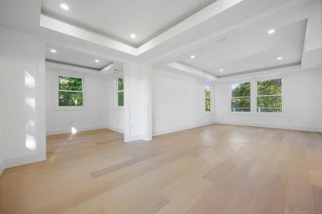 an empty room with windows and closet