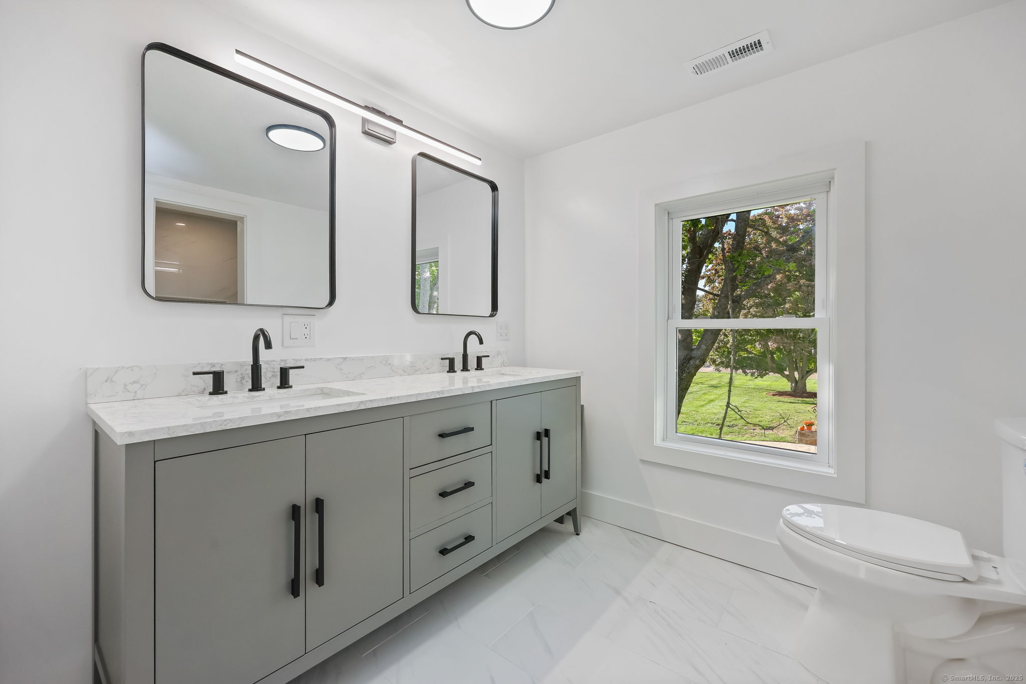 294 Thimble Island Road Branford, CT 06405 - Photo 20 of 39 a bathroom with a double vanity sink window and mirror