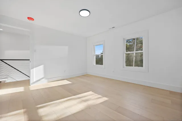 an empty room with windows and closet