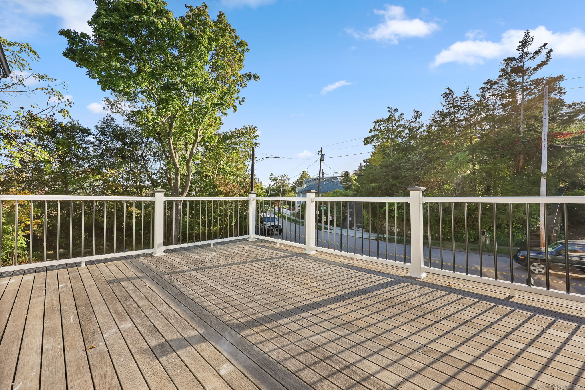 294 Thimble Island Road Branford, CT 06405 - Photo 31 of 39 a balcony with wooden floor and fence