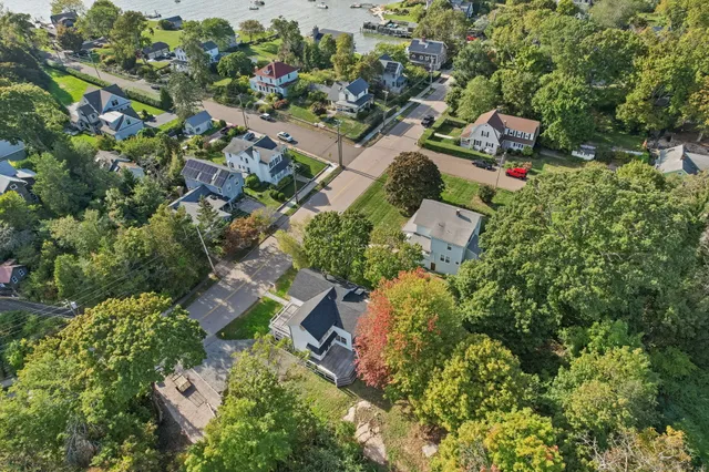 an aerial view of beach with residential house and ocean view
