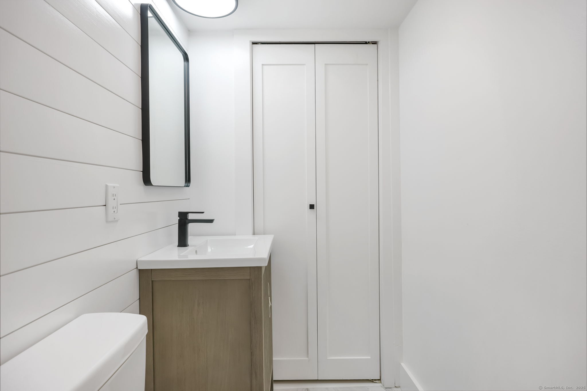 294 Thimble Island Road Branford, CT 06405 - Photo 8 of 39 a bathroom with a sink a toilet and mirror