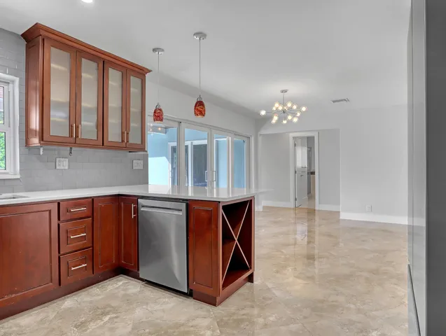 a kitchen with stainless steel appliances granite countertop a stove and a sink