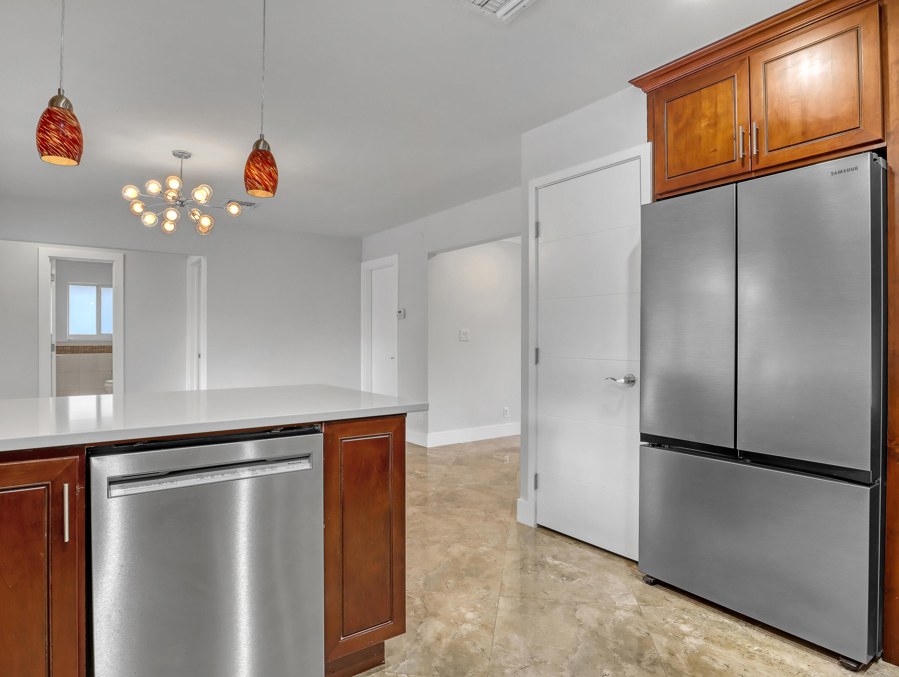 1298 Northwest 4th Street Boca Raton, FL 33486 - Photo 13 of 36 a view of a refrigerator in kitchen and an empty room