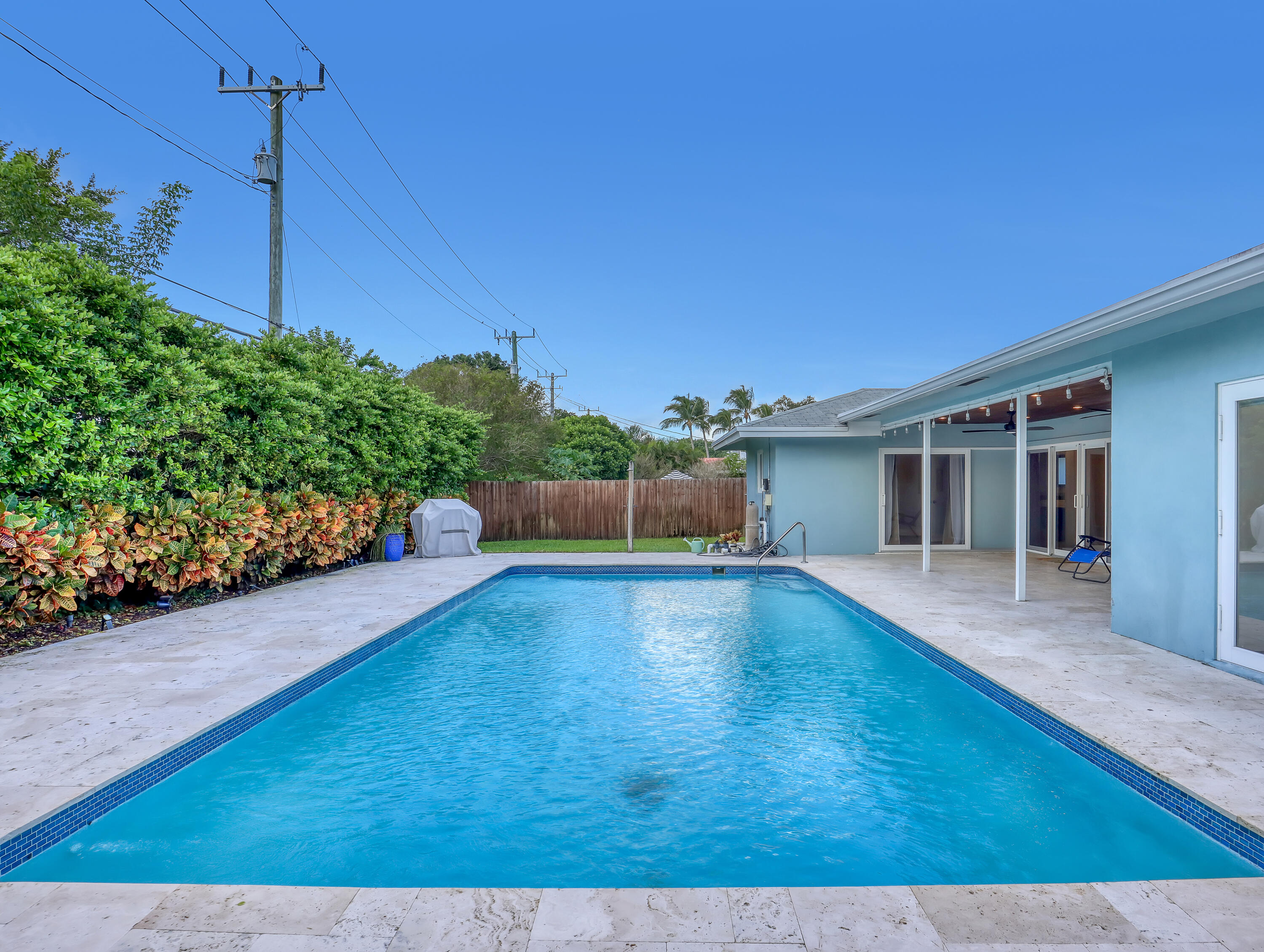 1298 Northwest 4th Street Boca Raton, FL 33486 - Photo 32 of 36 a view of a swimming pool with a patio