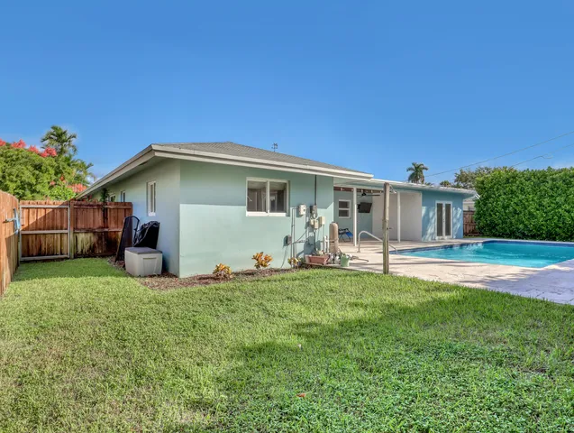 a big house with a big yard and large trees