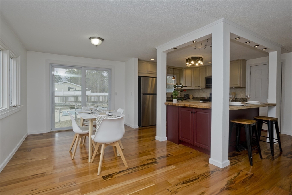 76 Paulk Terrace Springfield, MA 01128 - Photo 11 of 26 a kitchen with a dining table chairs and refrigerator