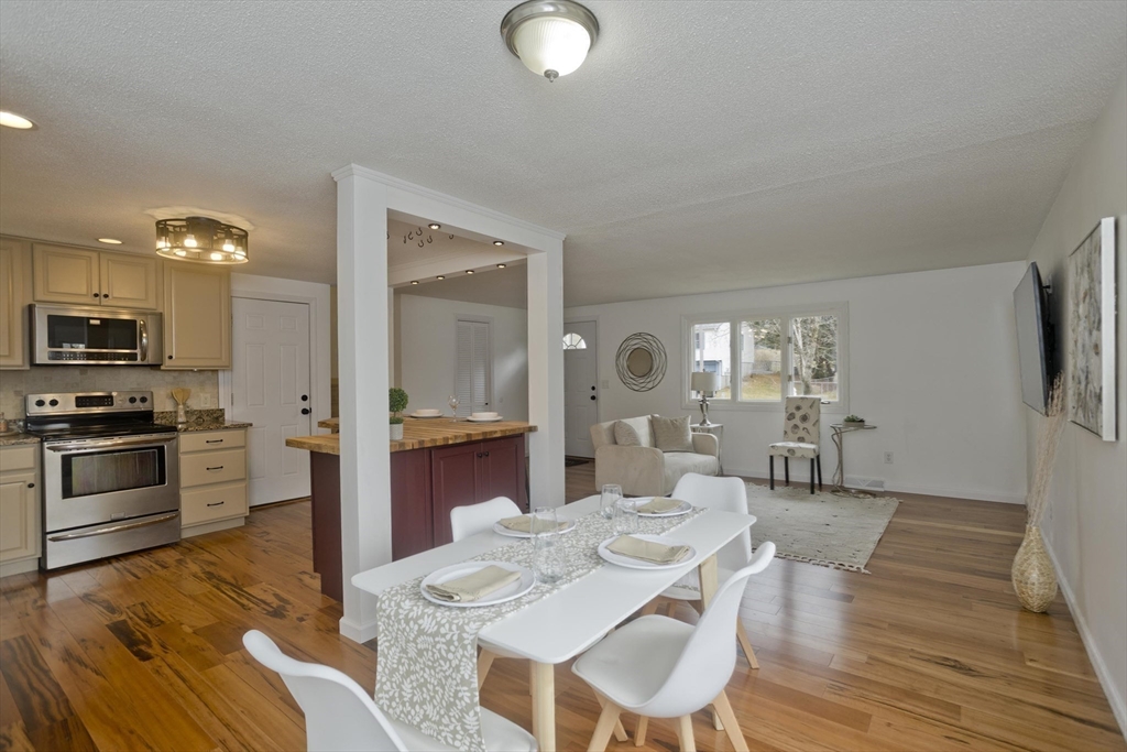 76 Paulk Terrace Springfield, MA 01128 - Photo 12 of 26 a large kitchen with cabinets wooden floor and stainless steel appliances
