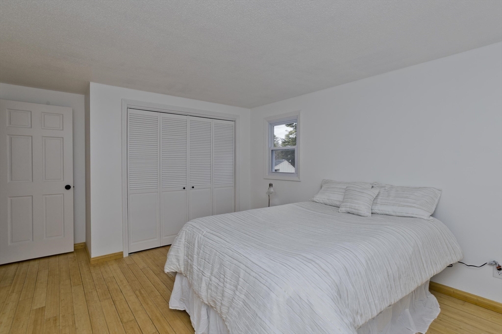 76 Paulk Terrace Springfield, MA 01128 - Photo 18 of 26 a bedroom with a bed and wooden floor