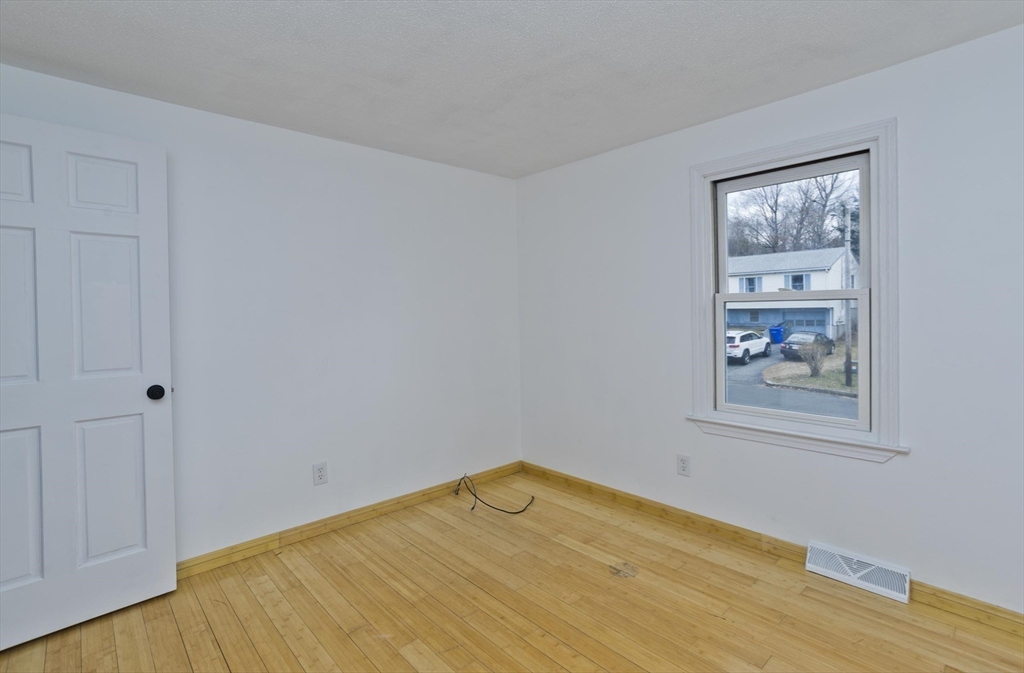 76 Paulk Terrace Springfield, MA 01128 - Photo 20 of 26 a view of empty room with wooden floor and fan