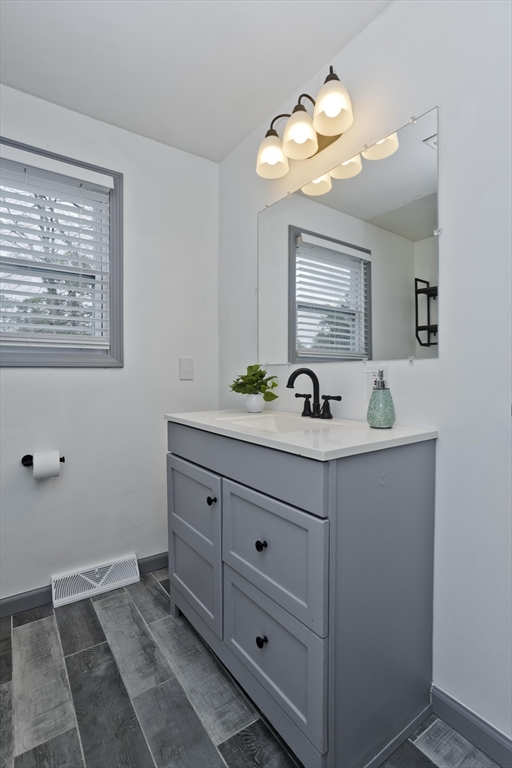 76 Paulk Terrace Springfield, MA 01128 - Photo 21 of 26 a bathroom with a sink a light fixture and a mirror