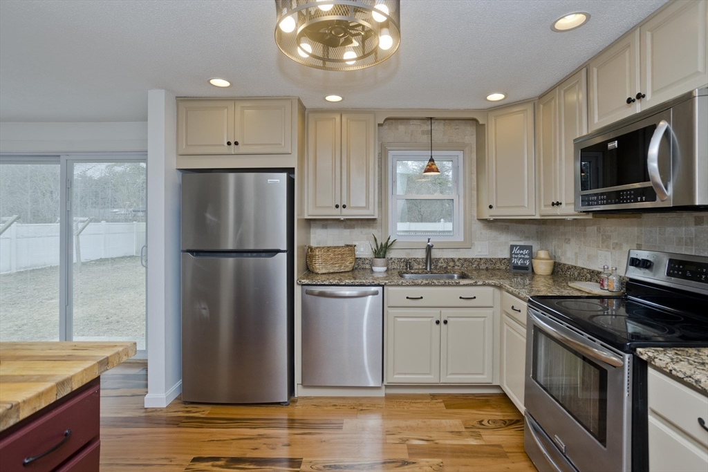 76 Paulk Terrace Springfield, MA 01128 - Photo 7 of 26 a kitchen with stainless steel appliances granite countertop a refrigerator stove top oven and sink